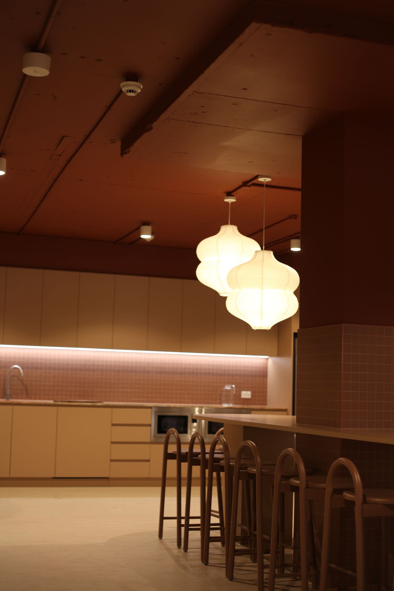 The café bar with pendant lights and timber stools
