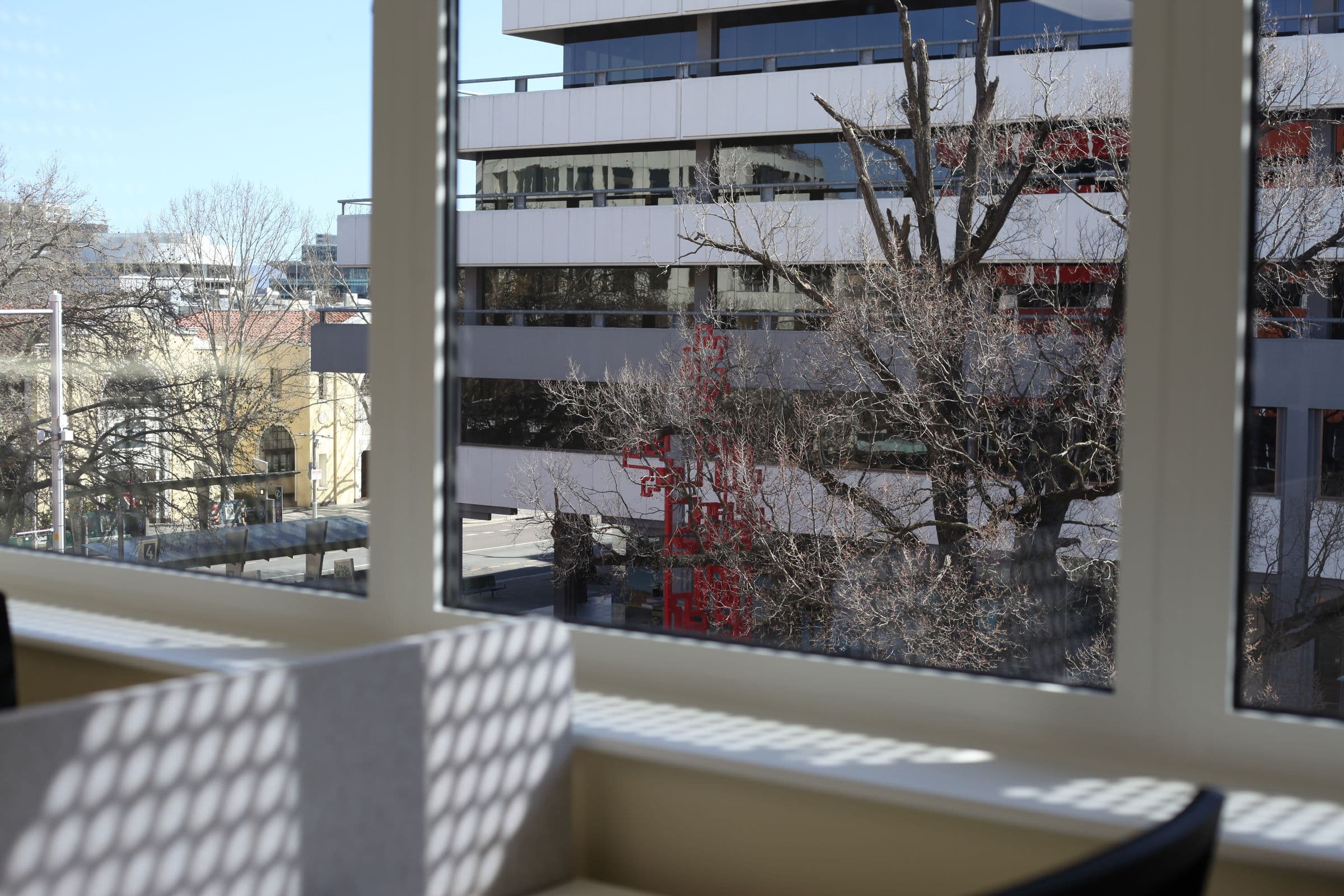 Dappled light on a desk by the window overlooking Canberra City