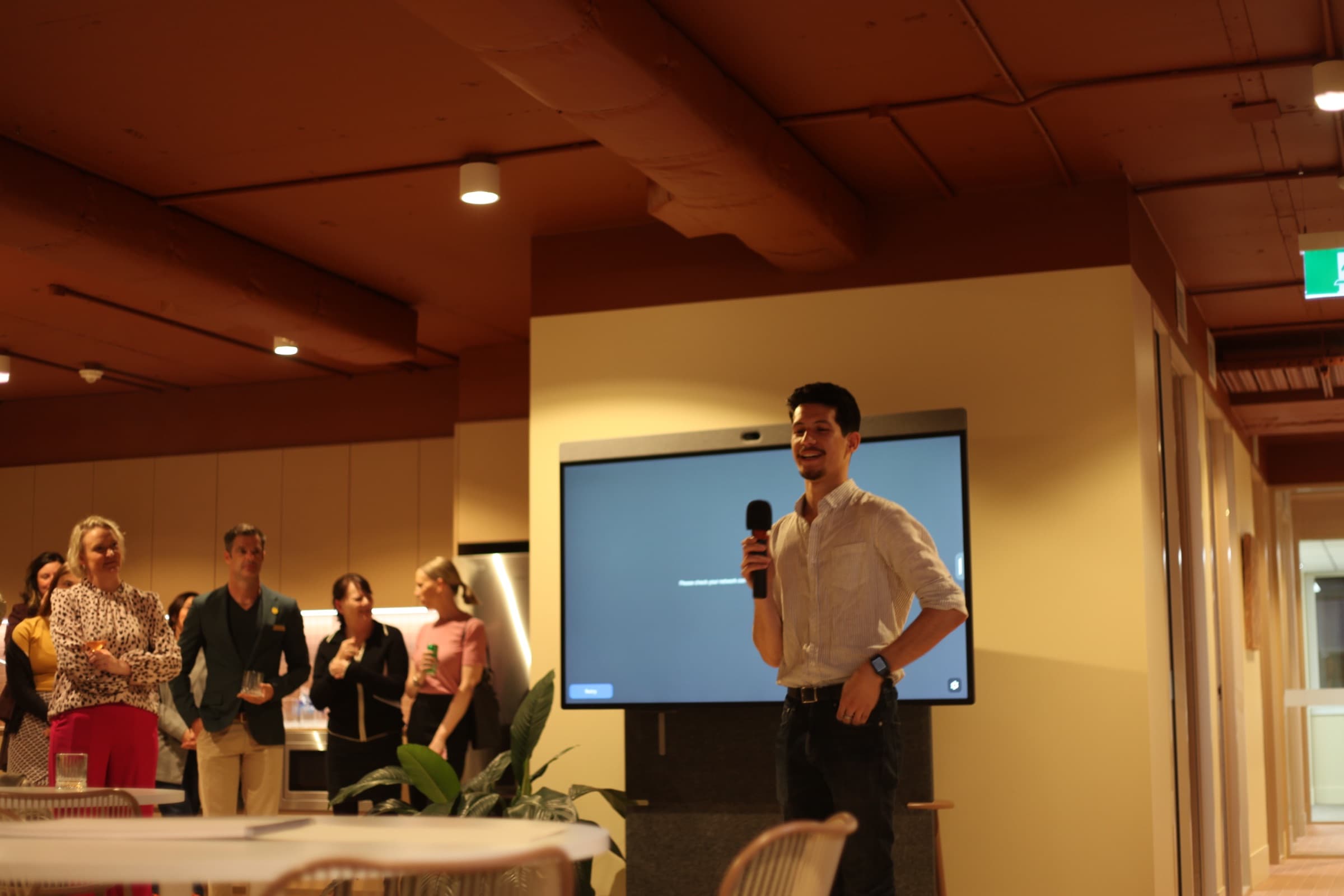A speaker with a microphone addressing guests